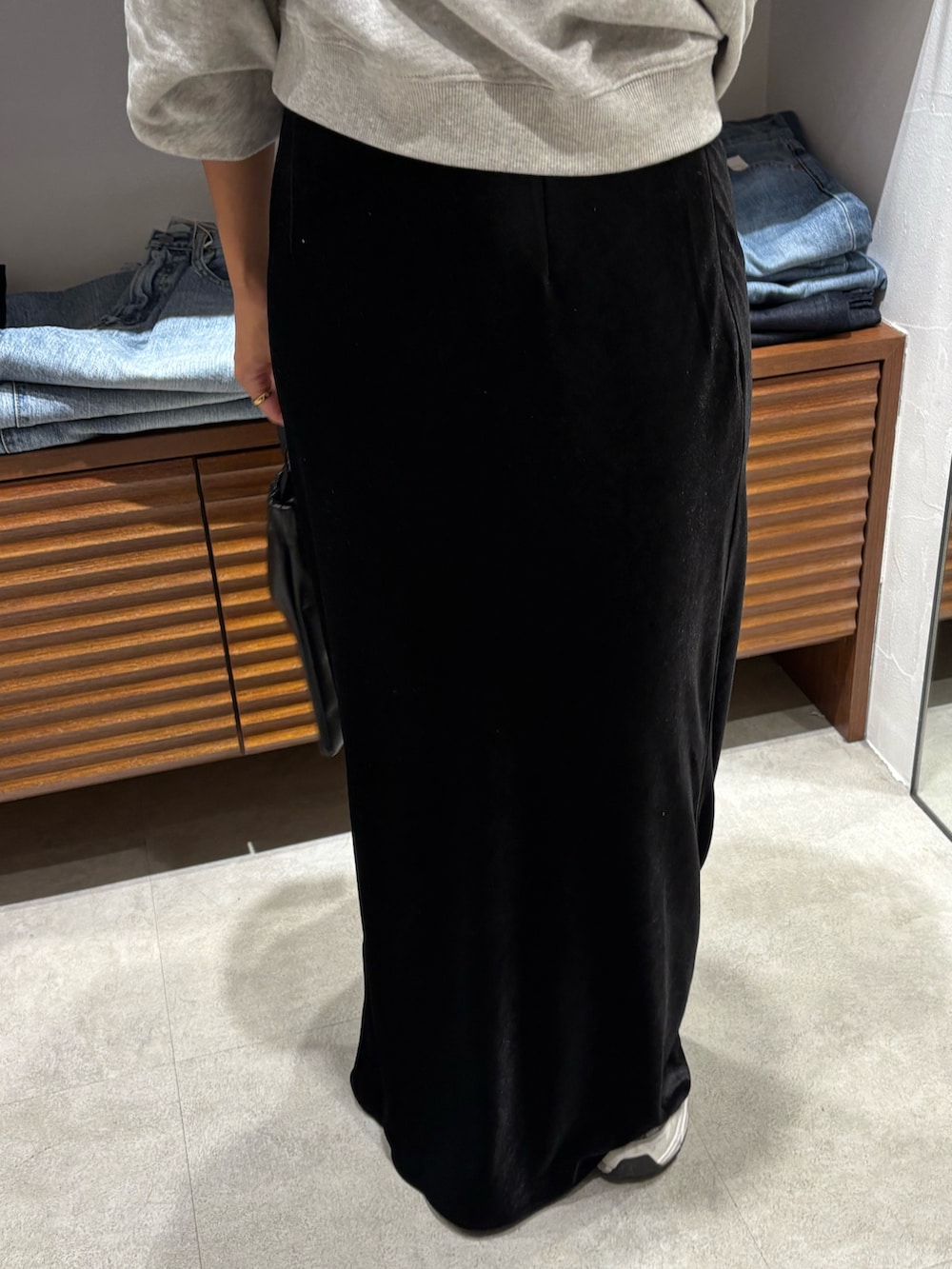 グレー系のスウェット、ブラック系のスカートを着用したレディースの秋コーディネートの5枚目の写真