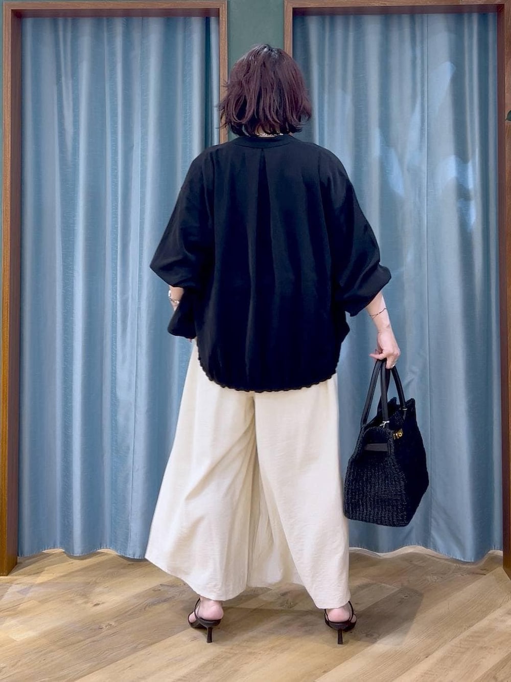 ブラック系のブルゾン、ホワイト系のその他パンツ、グレー系のTシャツ/カットソーを着用したレディースの春コーディネートの5枚目の写真