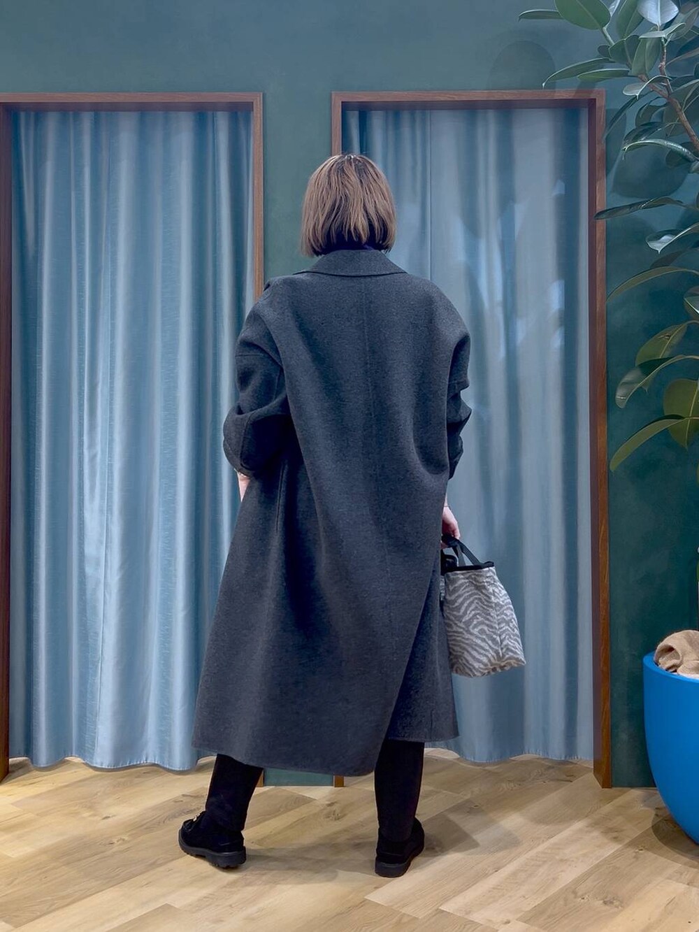 ブラック系のその他パンツ、パープル系のニット/セーター、グレー系のチェスターコートを着用したレディースの秋コーディネートの4枚目の写真