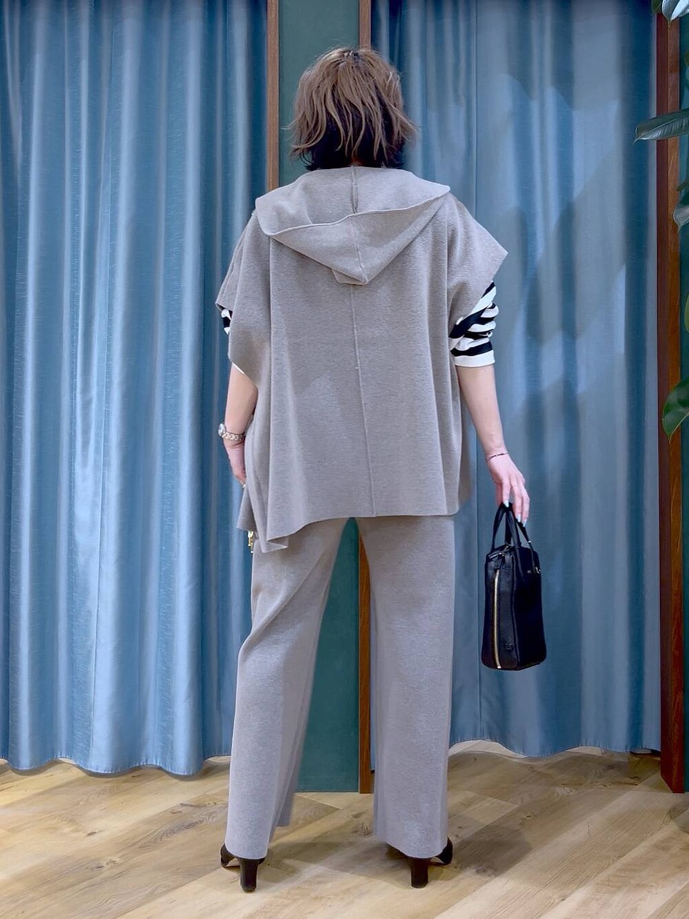 グレー系のベスト、グレー系のその他パンツ、ブラック系のブーツを着用したレディースの冬コーディネートの6枚目の写真