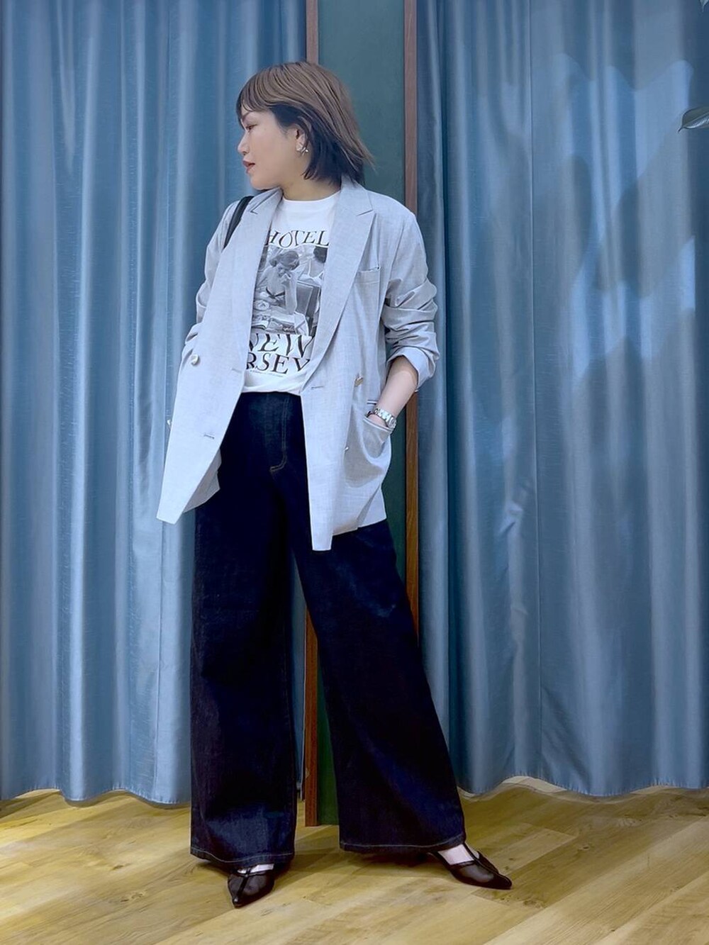 ブルー系のデニムパンツ、グレー系のテーラードジャケット、ホワイト系のTシャツ/カットソーを着用したレディースの冬コーディネートの2枚目の写真