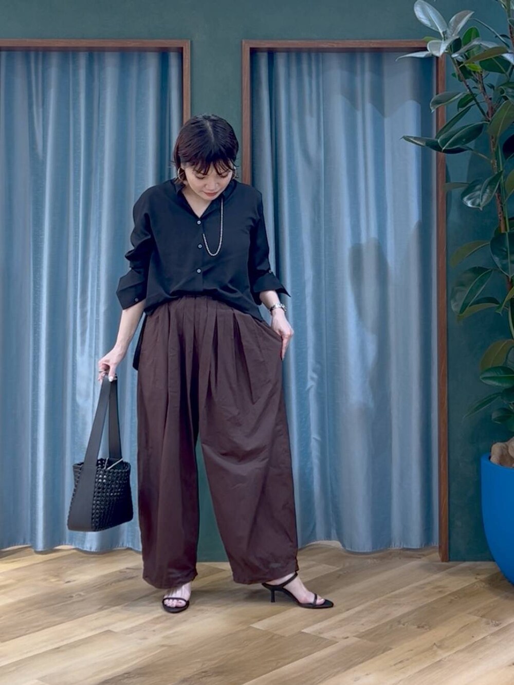 ブラウン系のその他パンツ、ブラック系のサンダル、ブラック系のハンドバッグを着用したレディースの夏コーディネートの2枚目の写真