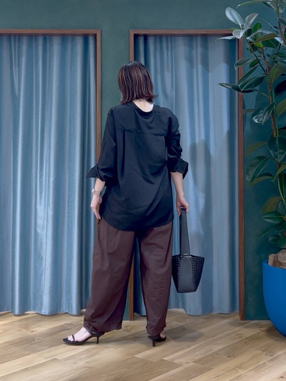 ブラウン系のその他パンツ、ブラック系のサンダル、ブラック系のハンドバッグを着用したレディースの夏コーディネートの4枚目の写真