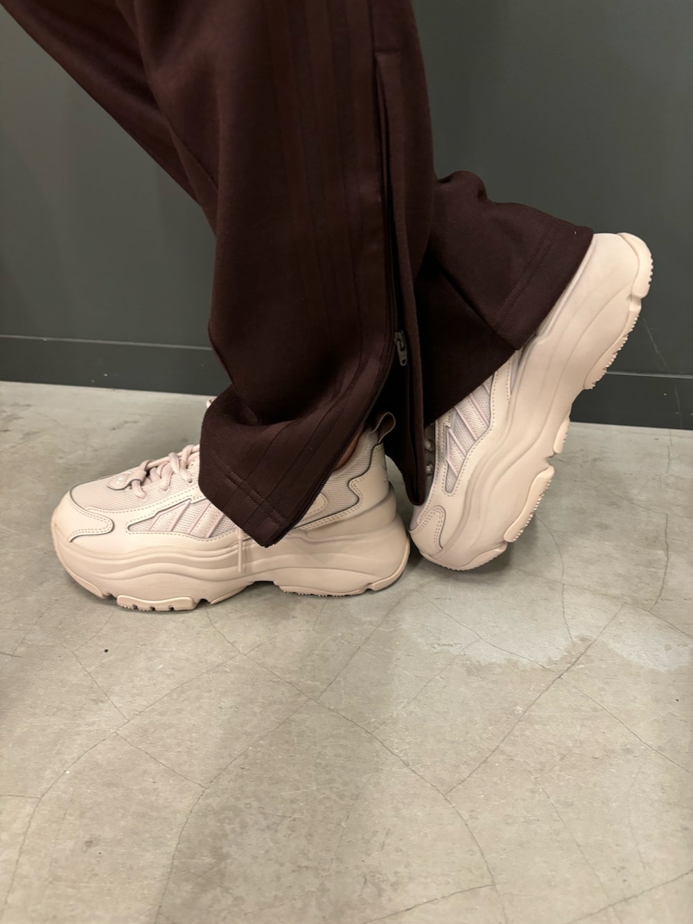 ブラウン系のジャージ、ブラウン系のその他パンツ、ベージュ系のスニーカーを着用したレディースの秋コーディネートの2枚目の写真