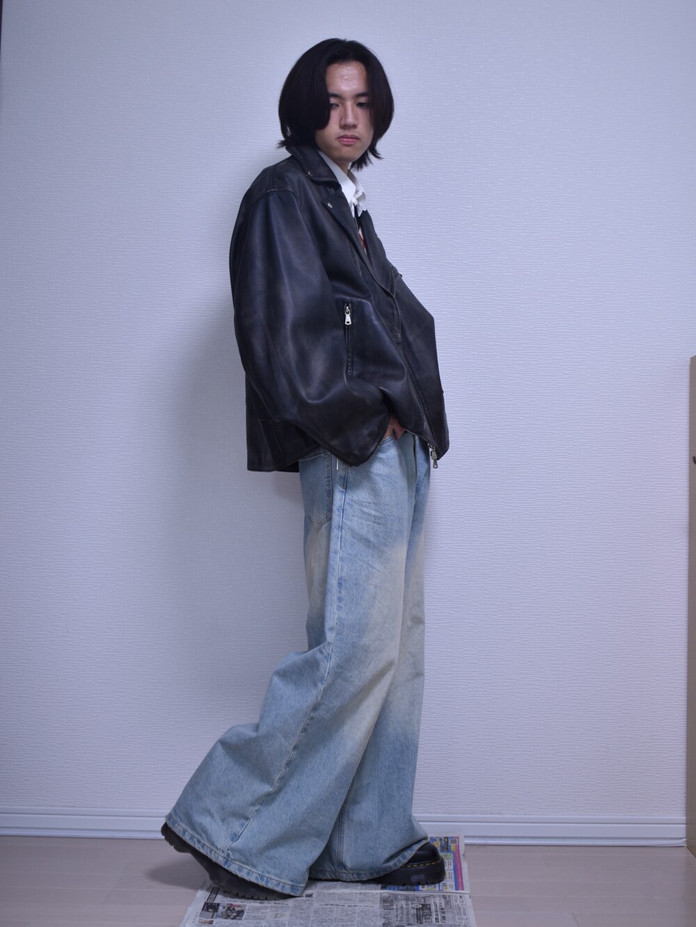 ブルー系のデニムパンツ、ブラック系のライダースジャケット、その他のベストを着用したメンズの秋コーディネートの4枚目の写真