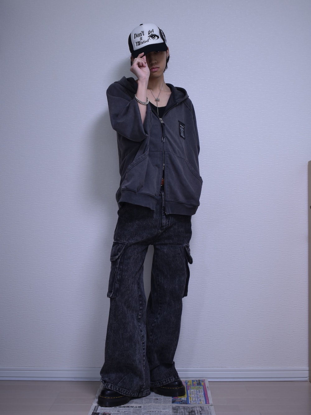 ブラック系のカーゴパンツ、グレー系のパーカー、ブラック系のブーツを着用したメンズの夏コーディネートの2枚目の写真