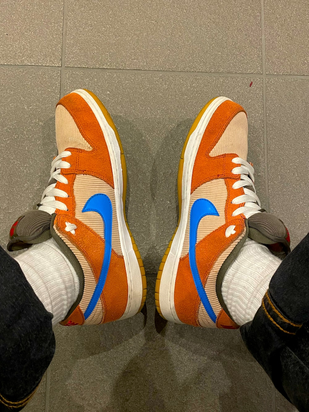 ブラウン系のシャツ/ブラウス、ブラック系のデニムパンツ、オレンジ系のスニーカーを着用したメンズの春コーディネートの2枚目の写真