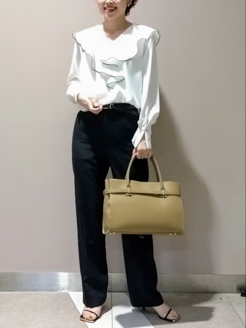 ホワイト系のシャツ/ブラウス、ホワイト系のキャミソール、ベージュ系のトートバッグを着用したレディースの冬コーディネートの2枚目の写真