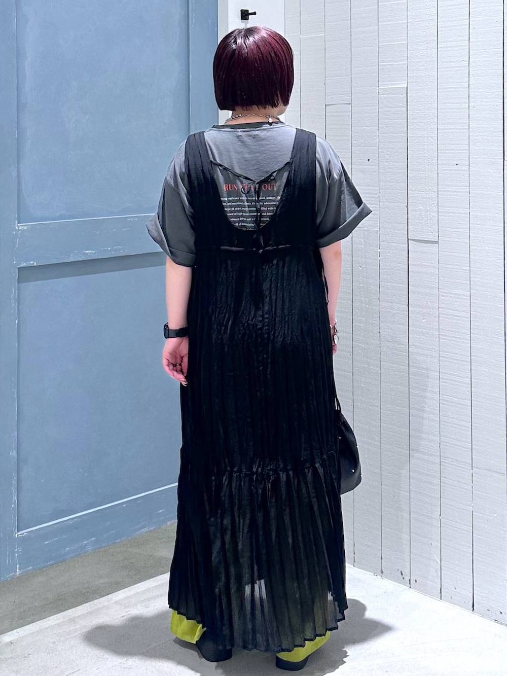 ブラック系のサンダル、ブラック系のショルダーバッグ、グリーン系のスラックスを着用したレディースの夏コーディネートの4枚目の写真