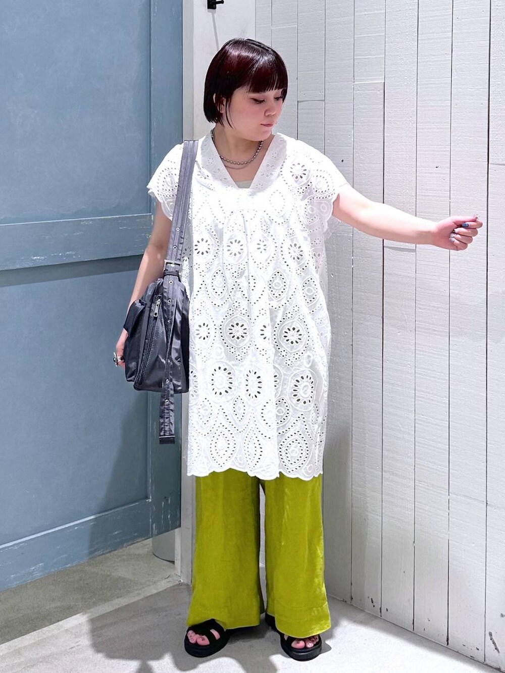 ホワイト系のワンピース、ブラック系のスニーカー、グリーン系のスラックスを着用したレディースの夏コーディネートの5枚目の写真