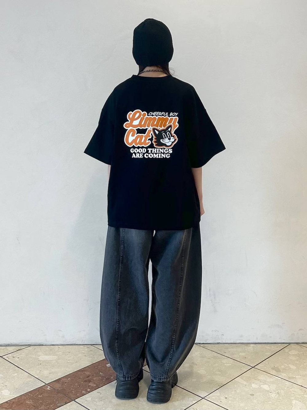 ブラック系のスニーカー、ブラック系のデニムパンツ、ブラック系のTシャツ/カットソーを着用したレディースの春コーディネートの4枚目の写真