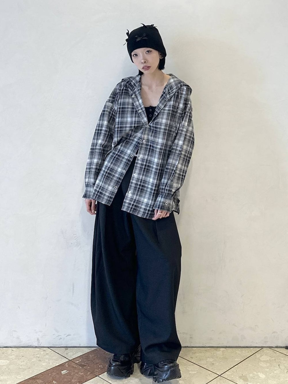 ブラック系のスニーカー、ブラック系のシャツ/ブラウス、ブラック系のスラックスを着用したレディースの春コーディネートの2枚目の写真