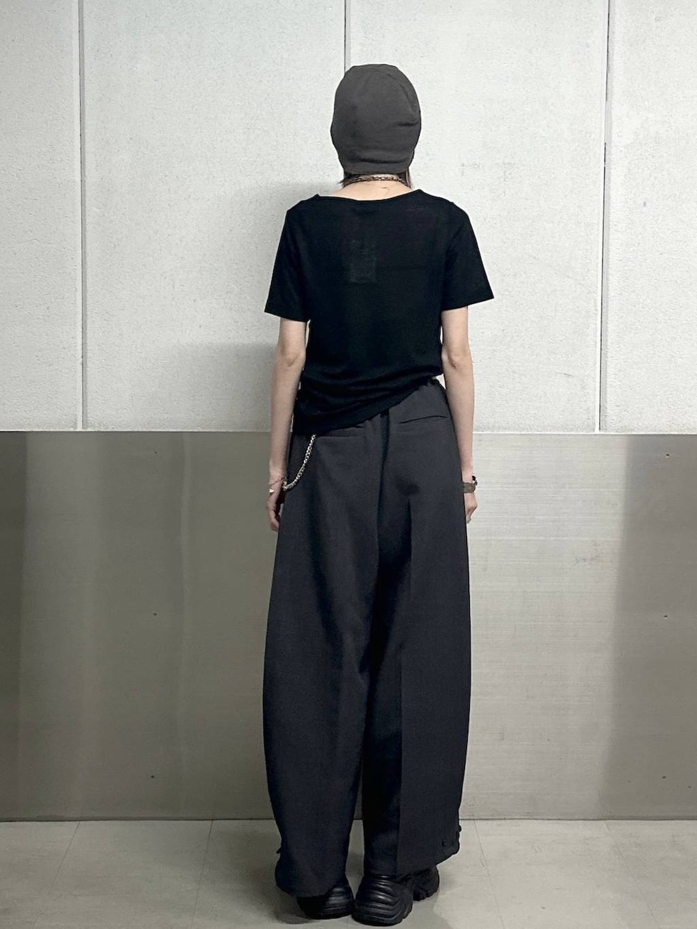 ブラック系のスニーカー、グレー系のスラックス、ブラック系のTシャツ/カットソーを着用したレディースの春コーディネートの4枚目の写真
