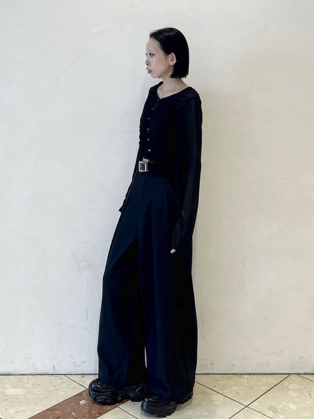 ブラック系のスニーカー、ブラック系のスラックス、ブラック系のTシャツ/カットソーを着用したレディースの春コーディネートの3枚目の写真