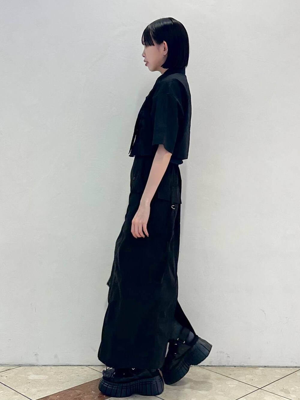 ブラック系のスニーカー、ブラック系のシャツ/ブラウス、ブラック系のショルダーバッグを着用したレディースの春コーディネートの3枚目の写真