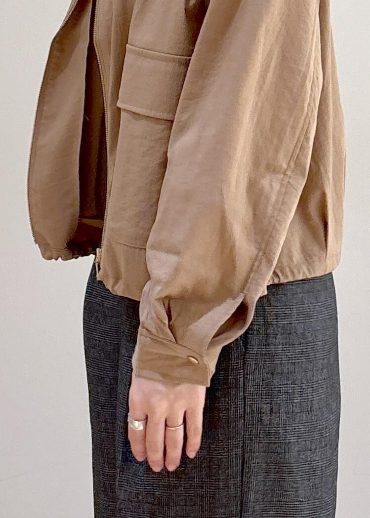 ベージュ系のブルゾン、グレー系のスラックス、ブラック系のショルダーバッグを着用したレディースの秋コーディネートの8枚目の写真