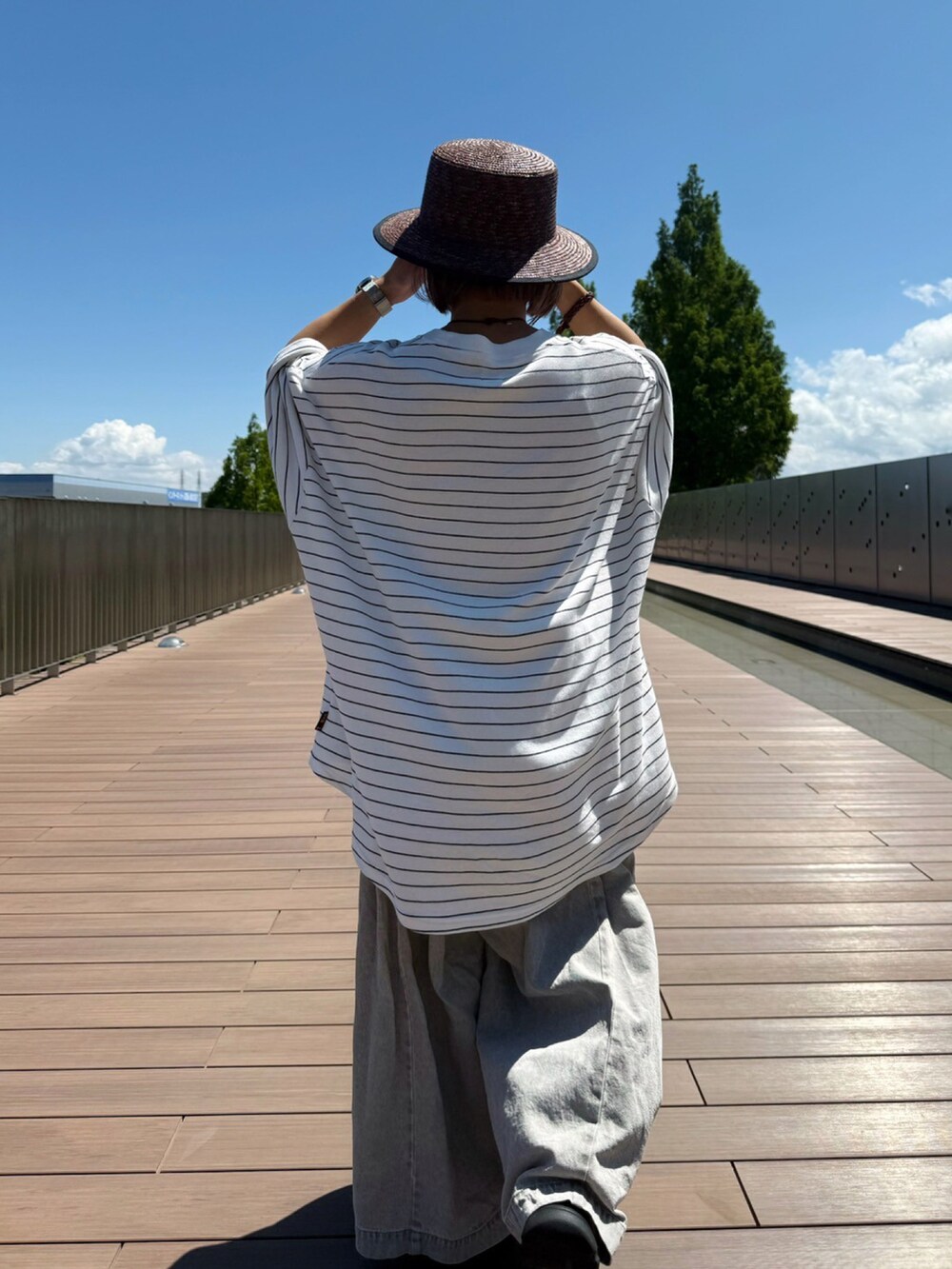 ホワイト系のトップスを着用したレディースの夏コーディネートの3枚目の写真