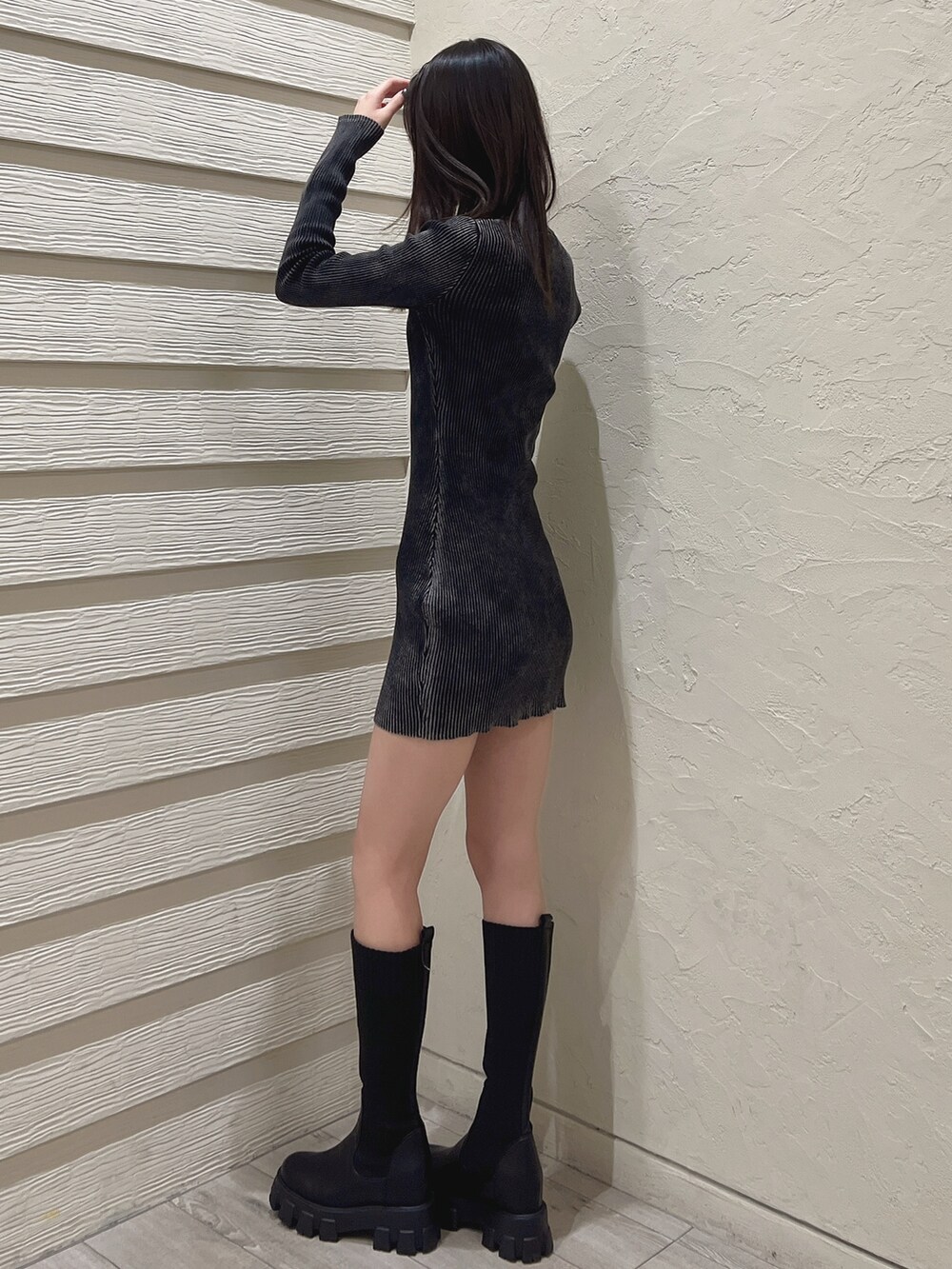 ブラック系のワンピース、ブラック系のブーツ、ホワイト系のブラジャーを着用したレディースの冬コーディネートの2枚目の写真