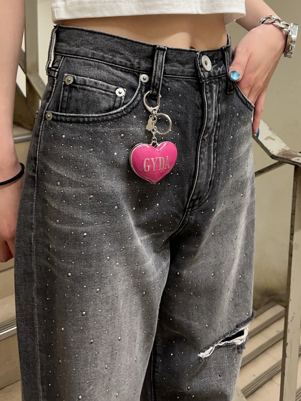 ホワイト系のTシャツ/カットソー、ブラック系のデニムパンツ、ホワイト系のサンダルを着用したレディースの春コーディネートの6枚目の写真