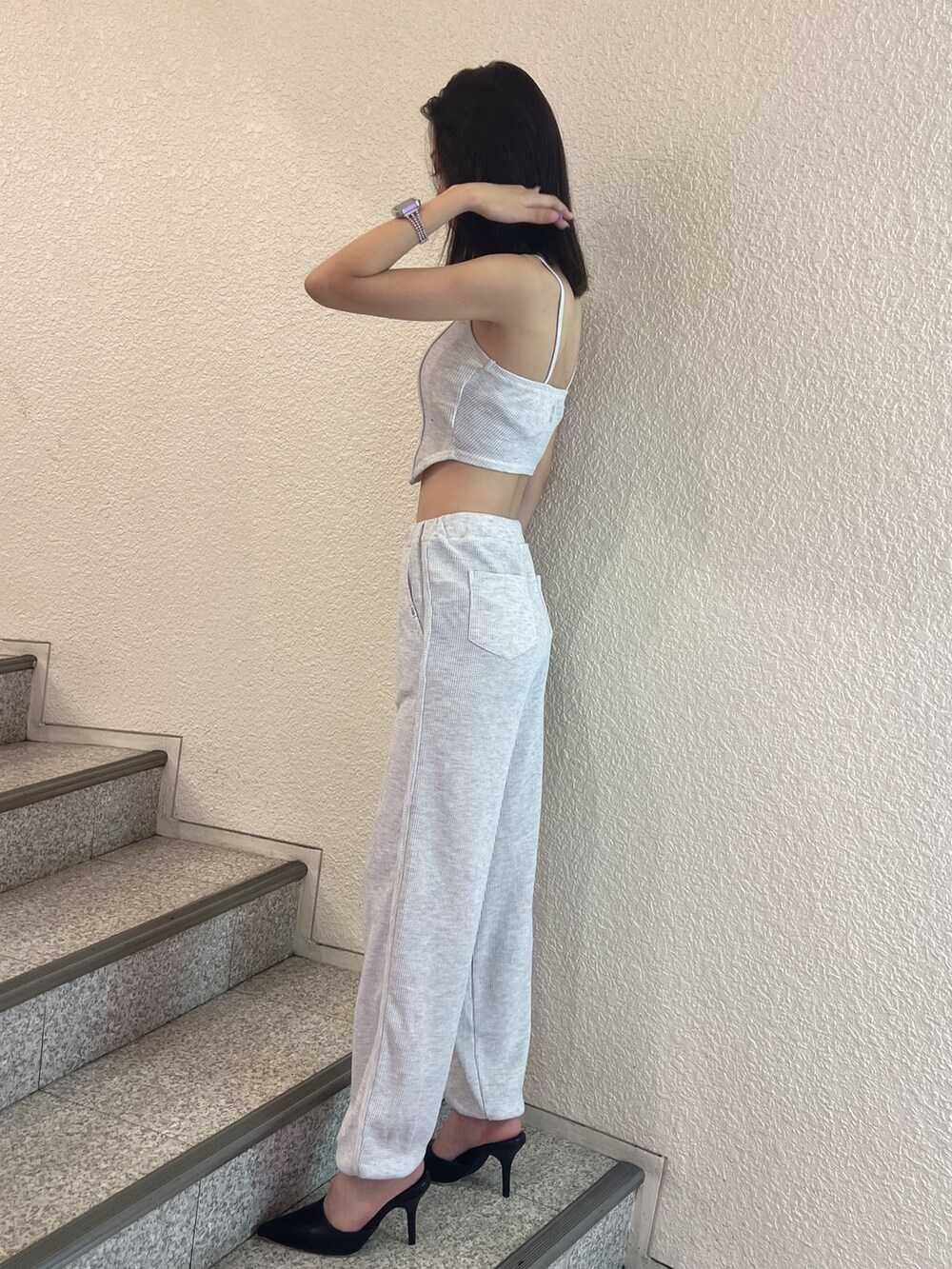 グレー系のスウェットパンツ、グレー系のキャミソール、ブラック系のパンプスを着用したレディースの夏コーディネートの3枚目の写真