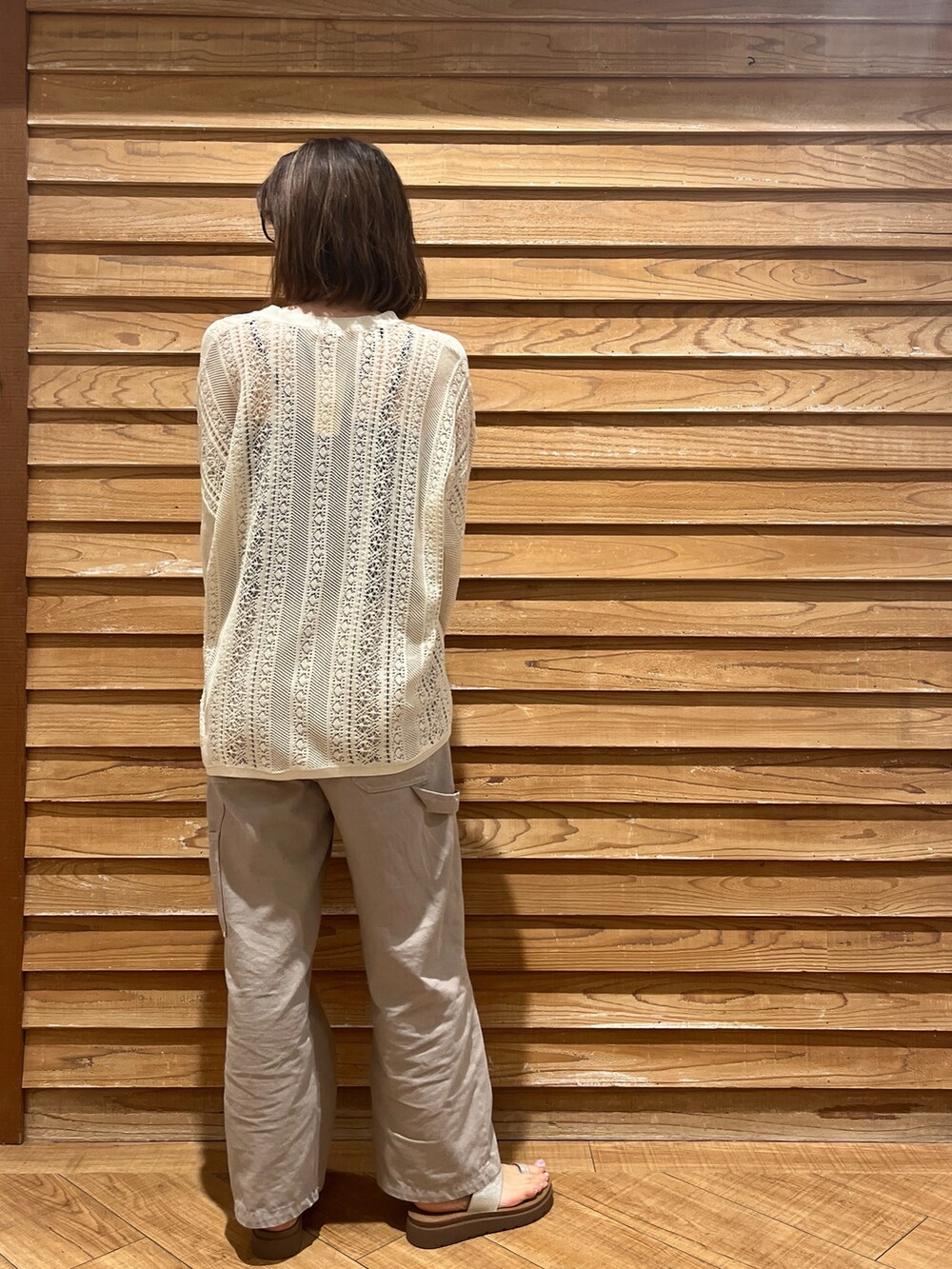ブラック系のキャミソール、ベージュ系のカーディガン/ボレロ、グレー系のデニムパンツを着用したレディースの春コーディネートの2枚目の写真