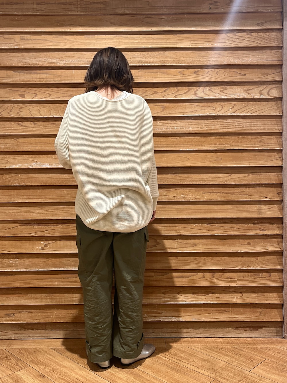 ホワイト系のニット/セーター、グリーン系のパンツ、シルバー系のシューズを着用したレディースの春コーディネートの3枚目の写真