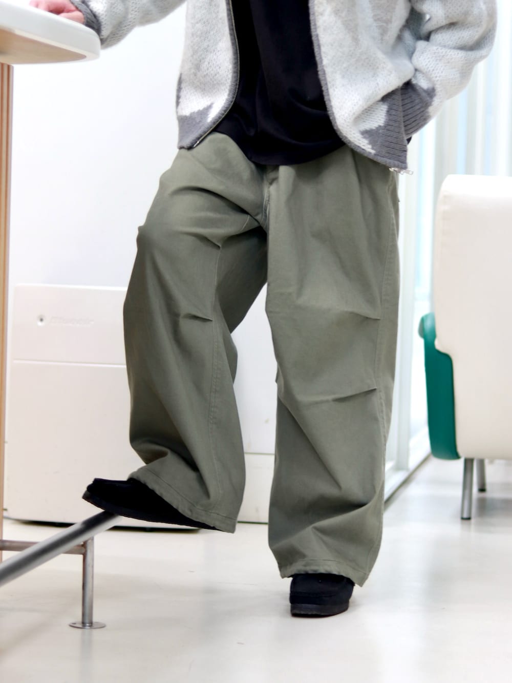 グレー系のニット/セーター、グリーン系のその他パンツを着用したメンズの秋コーディネートの4枚目の写真