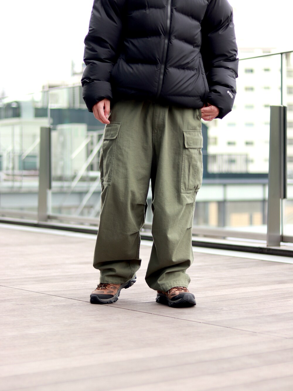 ブラック系のダウンジャケット/コート、グリーン系のカーゴパンツを着用したメンズの秋コーディネートの5枚目の写真