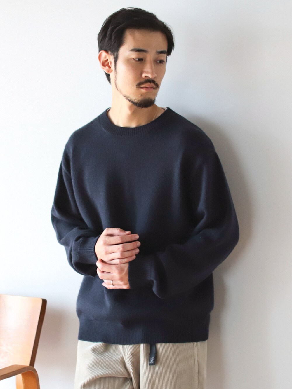 ブルー系のニット/セーターを着用したメンズの秋コーディネートの2枚目の写真