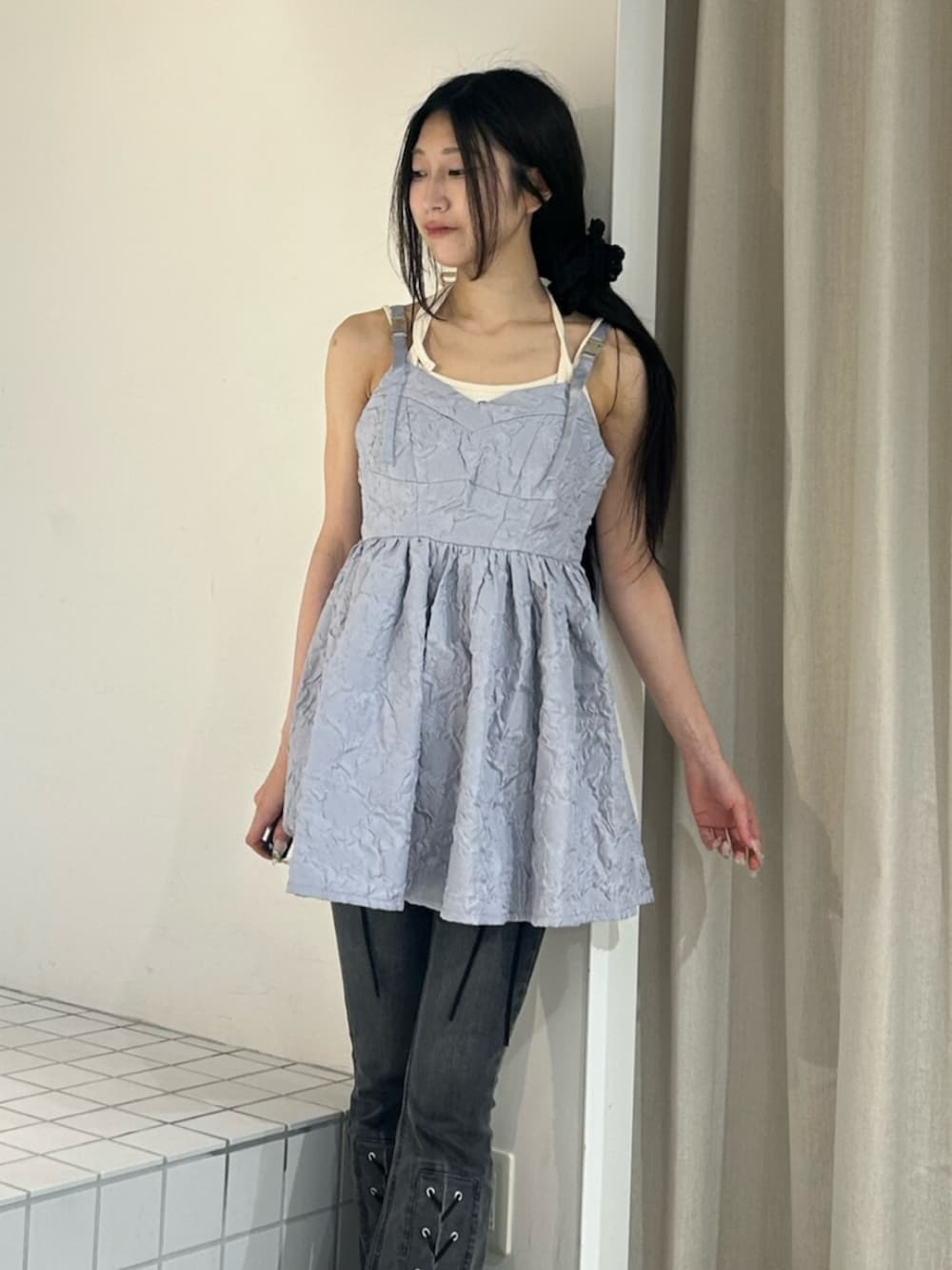 ブラック系のパンプス、ホワイト系のキャミソール、ブラック系のデニムパンツを着用したレディースの夏コーディネートの4枚目の写真