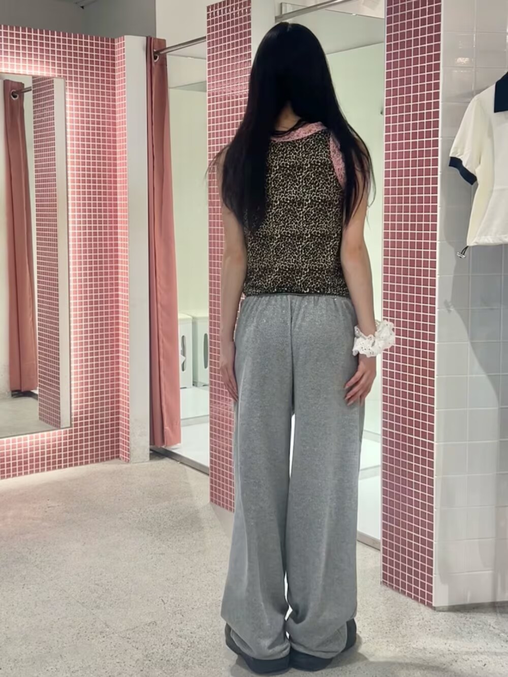 グレー系のスウェットパンツ、ブラウン系のタンクトップ、ホワイト系のシュシュを着用したレディースの夏コーディネートの3枚目の写真