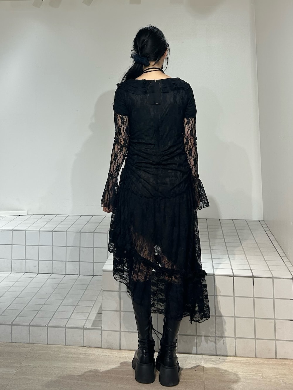 ブラック系のワンピース、ブラック系のブーツを着用したレディースの秋コーディネートの3枚目の写真