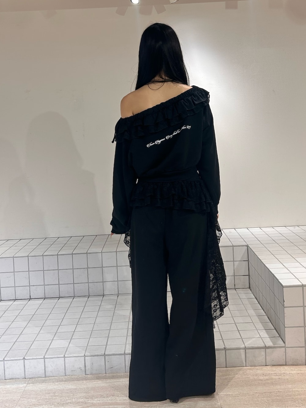 ブラック系のスウェット、ブラック系のスウェットパンツ、ブラック系のパンプスを着用したレディースの冬コーディネートの3枚目の写真