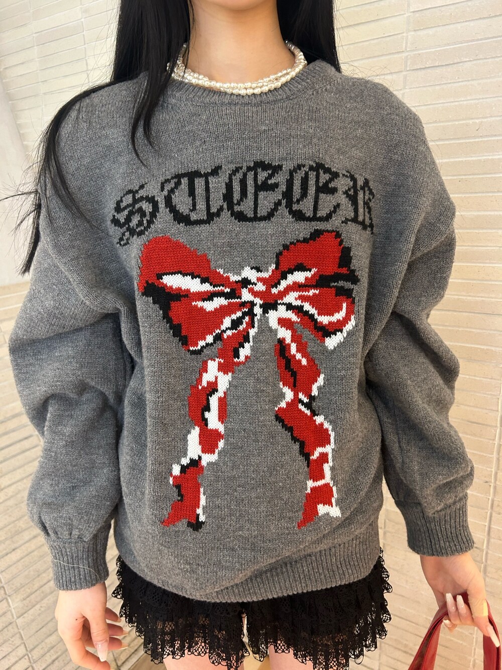 ゴールド系のパンプス、ブラック系のその他パンツ、レッド系のトートバッグを着用したレディースの冬コーディネートの5枚目の写真