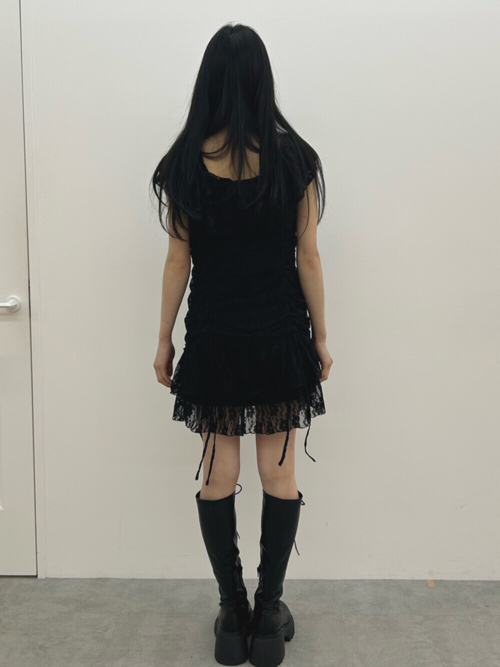 ブラック系のブーツ、ブラック系のワンピースを着用したレディースの夏コーディネートの3枚目の写真