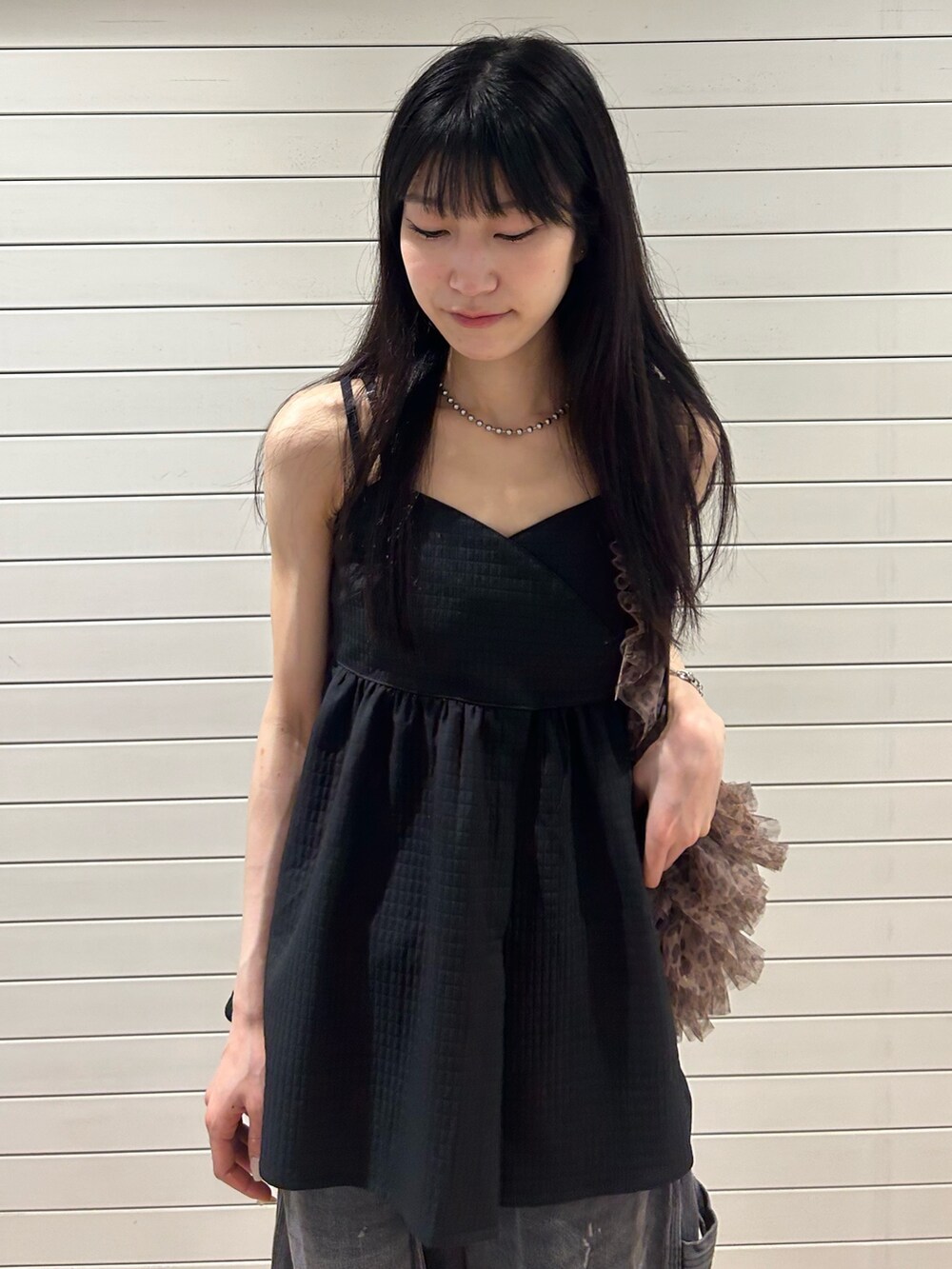 ブラック系のキャミソール、ブラック系のデニムパンツ、その他のショルダーバッグを着用したレディースの夏コーディネートの4枚目の写真