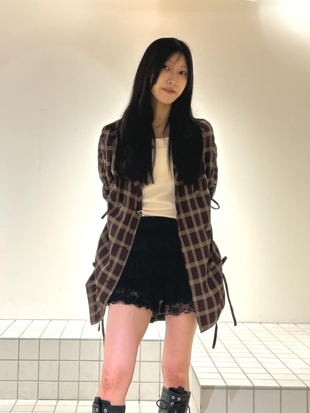 ホワイト系のキャミソール、ブラック系のブーツ、ブラック系のその他パンツを着用したレディースの秋コーディネートの4枚目の写真