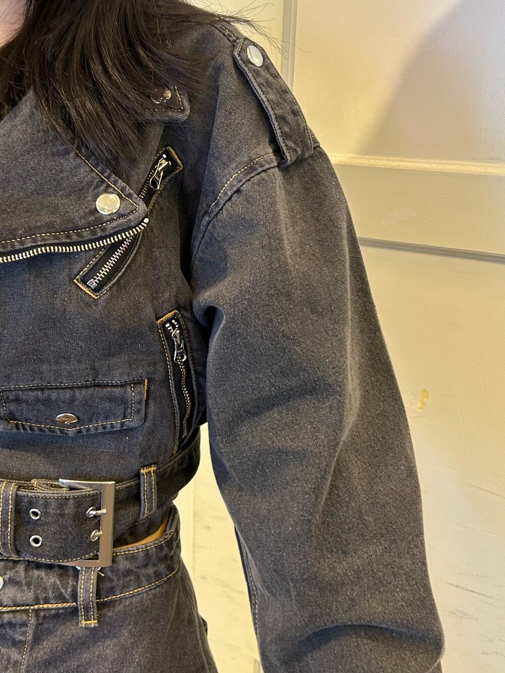 ブラック系のデニムパンツ、ブラック系のライダースジャケットを着用したレディースの秋コーディネートの5枚目の写真