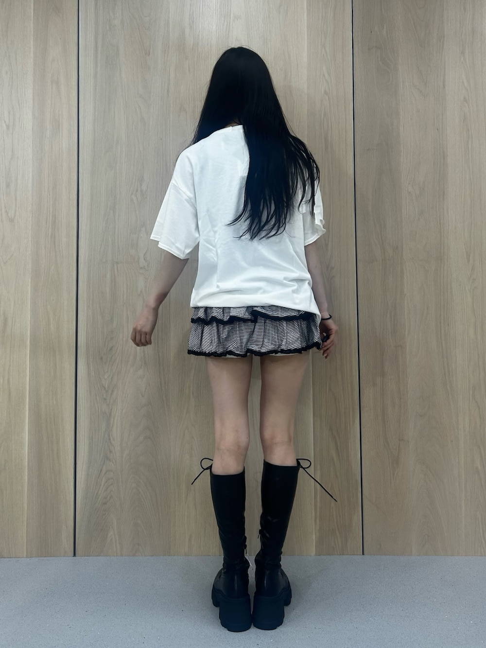 ホワイト系のTシャツ/カットソー、その他のスカート、ブラック系のブーツを着用したレディースの春コーディネートの3枚目の写真