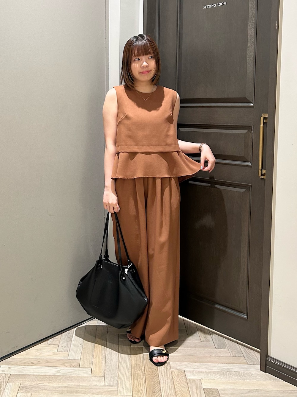 イエロー系のシャツ/ブラウス、イエロー系のその他パンツ、ブラック系のトートバッグを着用したレディースの秋コーディネートの2枚目の写真
