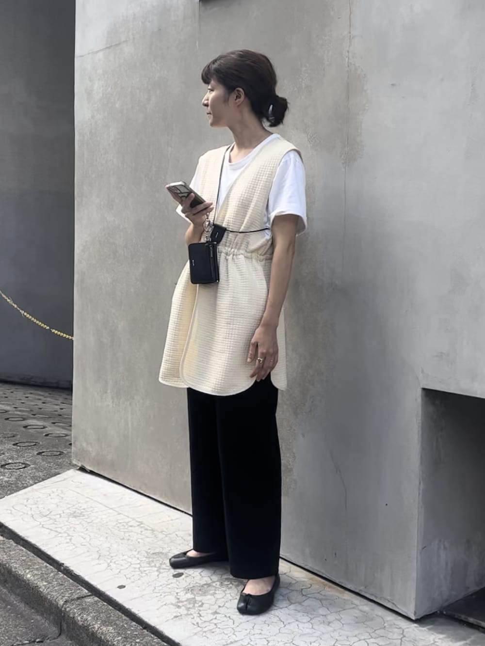 ベージュ系のベスト、ホワイト系のTシャツ/カットソー、ブラック系のその他パンツを着用したレディースの夏コーディネートの2枚目の写真