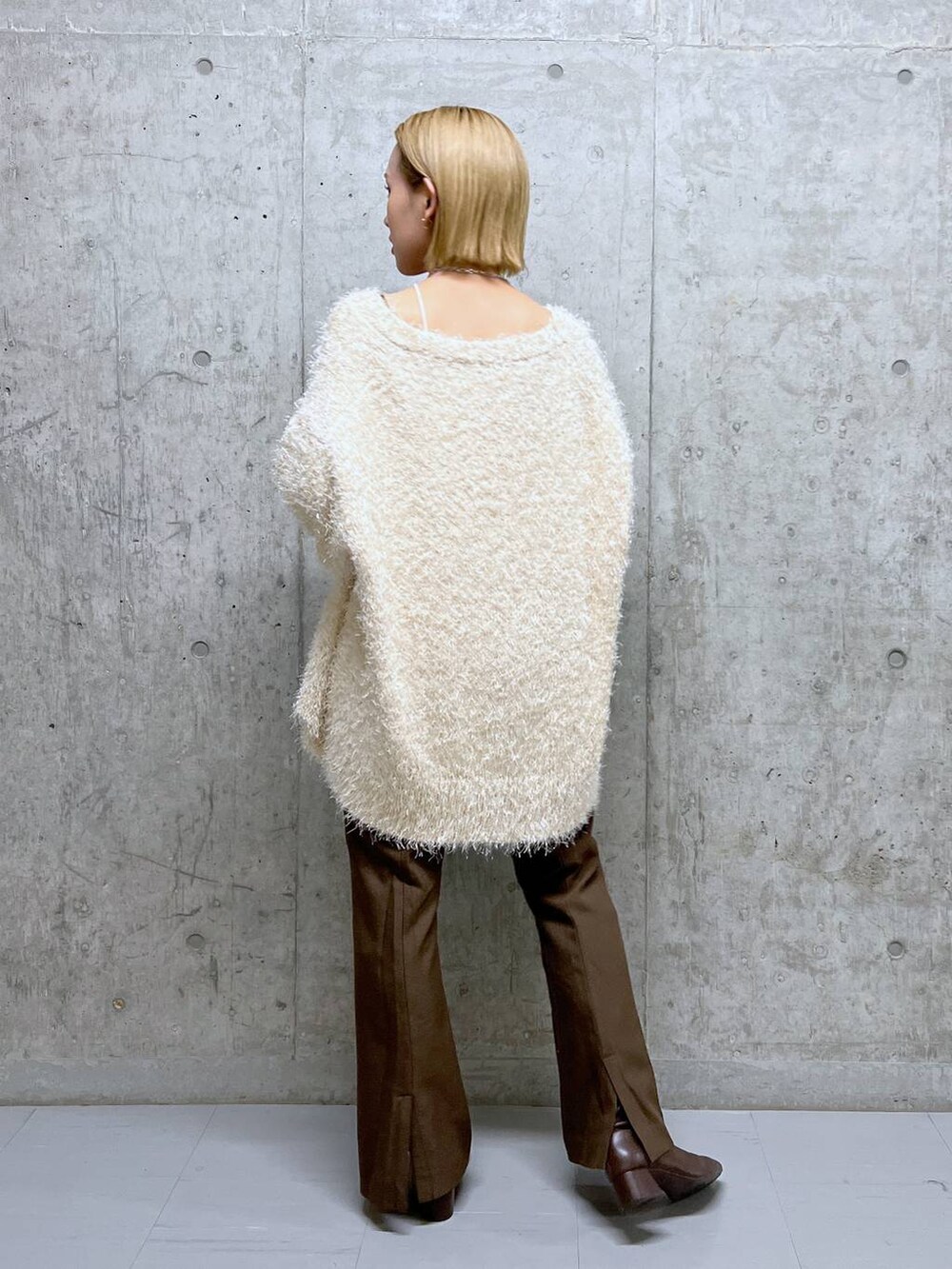 ホワイト系のタンクトップ、ブラウン系のブーツ、ホワイト系のカーディガン/ボレロを着用したレディースの秋コーディネートの4枚目の写真