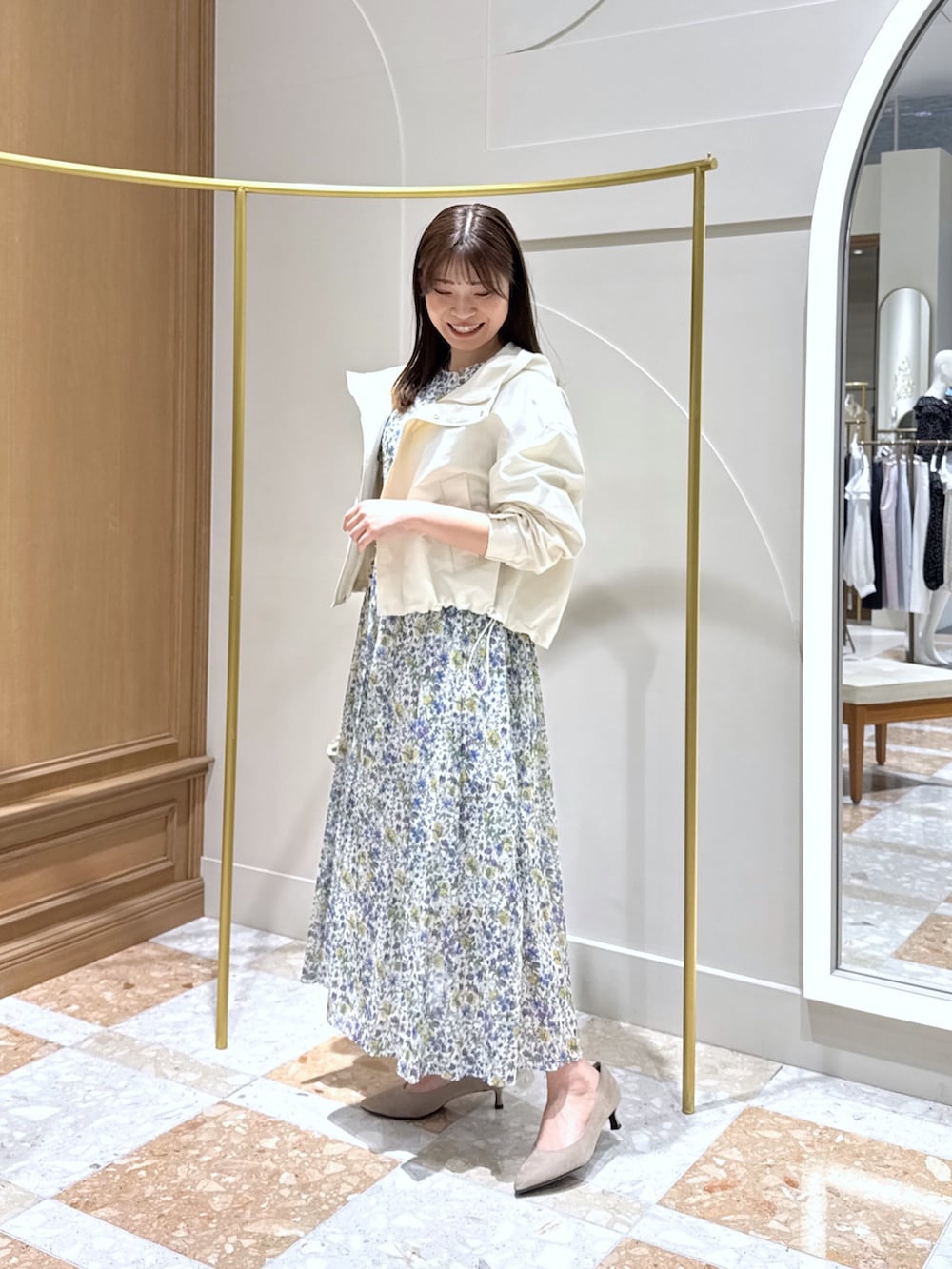 ホワイト系のブルゾン、ホワイト系のワンピース、ベージュ系のかごバッグを着用したレディースの春コーディネートの2枚目の写真