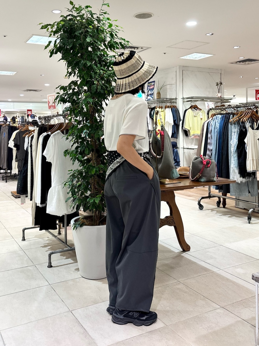 グレー系のその他パンツ、ホワイト系のニット/セーター、ブラック系のバンダナ/スカーフを着用したレディースの夏コーディネートの2枚目の写真