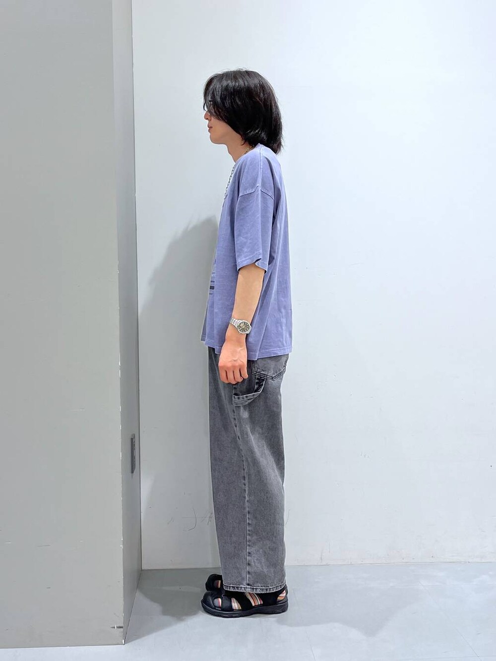 ブラック系のサンダル、グレー系のデニムパンツ、パープル系のTシャツ/カットソーを着用したメンズの夏コーディネートの2枚目の写真