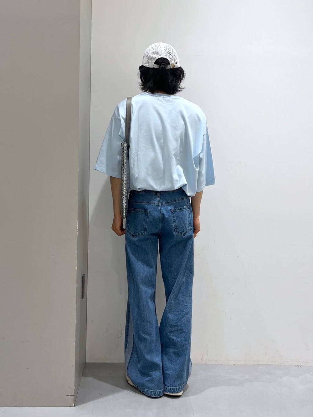 グレー系のトートバッグ、ブルー系のデニムパンツ、ブルー系のTシャツ/カットソーを着用したメンズの夏コーディネートの4枚目の写真
