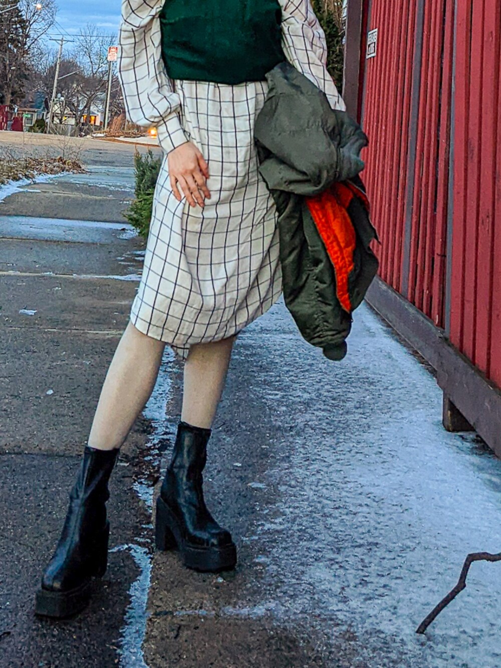 ホワイト系のシャツワンピース、ブラック系のブーツを着用したレディースの春コーディネートの2枚目の写真