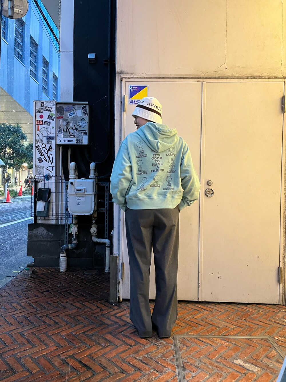 グレー系のパーカー、ホワイト系のハットを着用したレディースの冬コーディネートの2枚目の写真