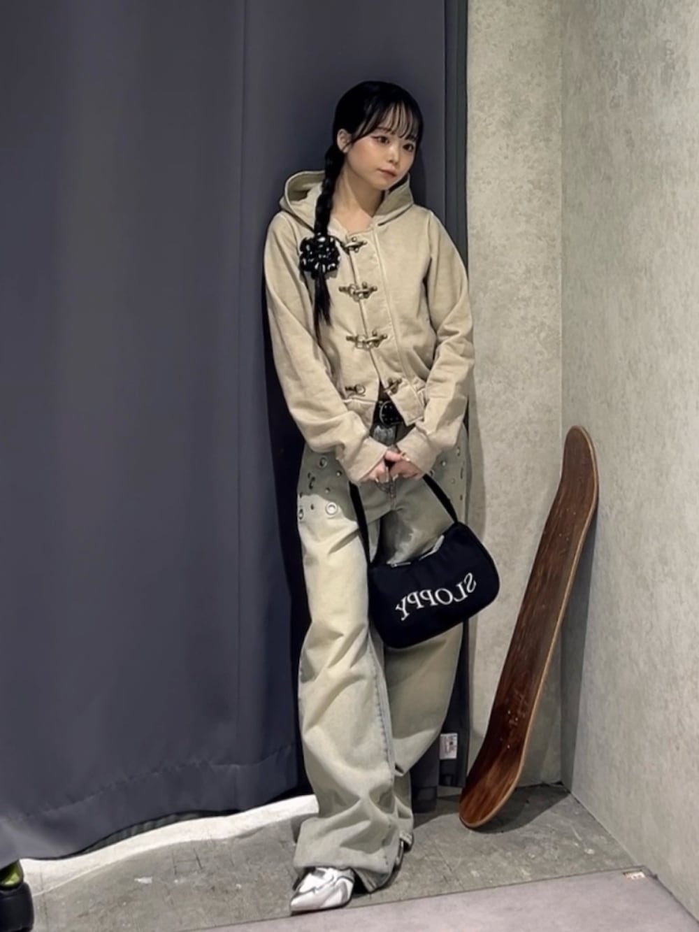 グレー系のパーカー、ブルー系のデニムパンツ、ブラック系のショルダーバッグを着用したレディースの冬コーディネートの2枚目の写真