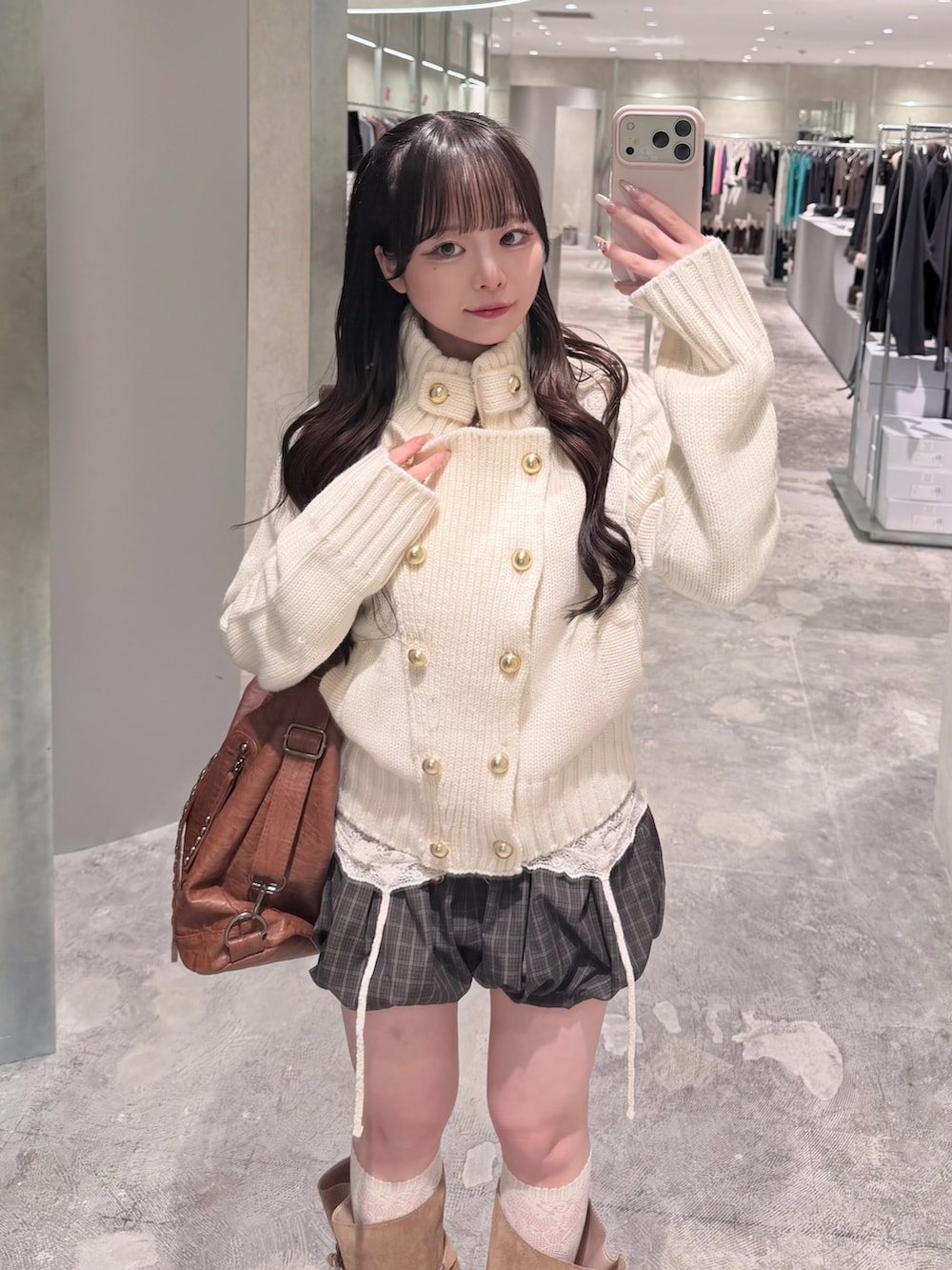 ホワイト系のニット/セーター、ブラウン系のパンツ、ホワイト系のキャミソールを着用したレディースの秋コーディネートの2枚目の写真